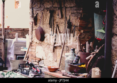 Various rusty tools hanging on a wall Stock Photo