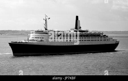 AJAXNETPHOTO. 16TH MAY, 1969. SOLENT, ENGLAND. - NATO FLEET SPECTATOR - CUNARD LINER QUEEN ELIZABETH 2 OUTWARD BOUND FROM SOUTHAMPTON OFF RYDE PASSING THE NATO WARSHIP FLEET ASSEMBLED FOR H.M. QUEEN ELIZABETH II REVIEW. PHOTO:JONATHAN EASTLAND/AJAX REF:356918 2A Stock Photo