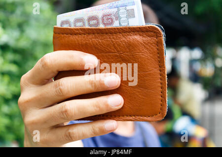 man showing money in wallet Stock Photo