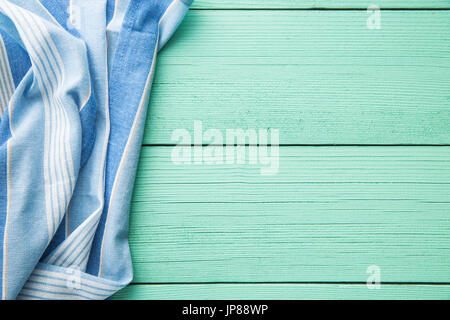 Tablecloth over colorful wooden table. Top view. Stock Photo