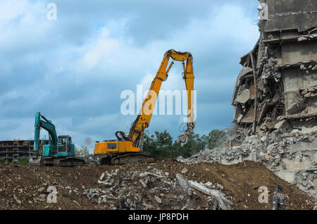 Heavy equipment being used to tear tearing down building construction Stock Photo