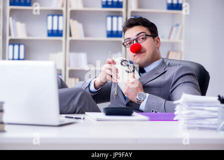 Clown businessman in the office with the a money sack Stock Photo