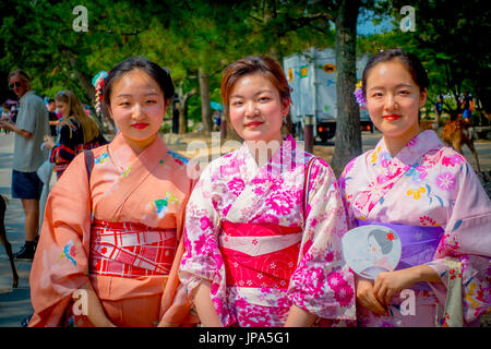 Nara, Japan - July 26, 2017: Unidentified women posing for camera in Nara park, Japan. Nara is a major tourism destination in Japan Stock Photo