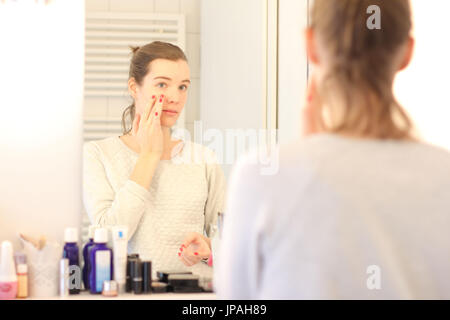 Young woman, mirror image, face, cream, Stock Photo
