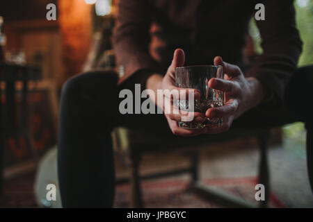 Alternative wedding, bridegroom, nervously, strain, wait, drink whisky, detail, hands, glass Stock Photo