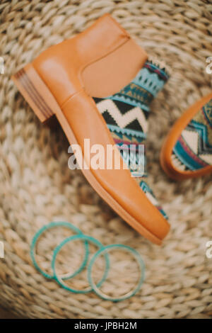 Women's shoes with Ethno pattern, bangles, still life Stock Photo