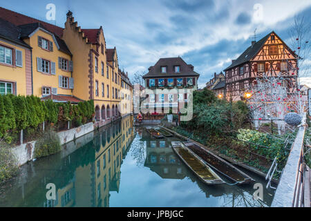 Dusk lights on houses reflected in river Lauch at Christmas Petite Venise Colmar Haut-Rhin department Alsace France Europe Stock Photo