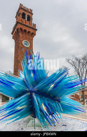 The blue glass sculpture frames the bell tower at Campo Santo Stefano Island of Murano Veneto Italy Europe Stock Photo