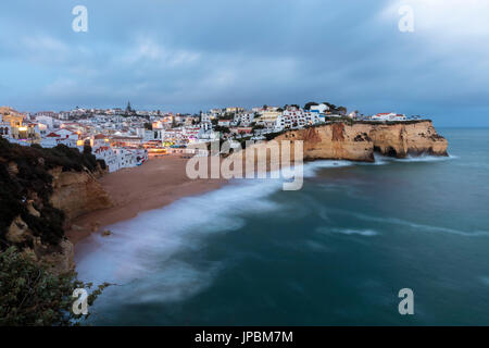 View of Carvoeiro village surrounded by sandy beach and clear sea at dusk Lagoa Municipality Algarve Portugal Europe Stock Photo