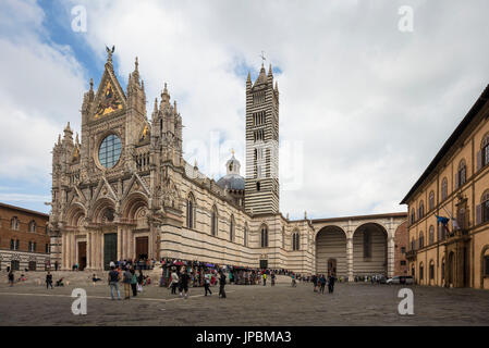 The white marble facade and the artistic decorations of the historical Siena Cathedral Tuscany Italy Europe Stock Photo