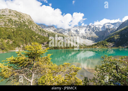 Rocky peaks and woods are reflected in Aviolo Lake Vezza D'Oglio Camonica Valley province of Brescia Lombardy Italy Europe Stock Photo