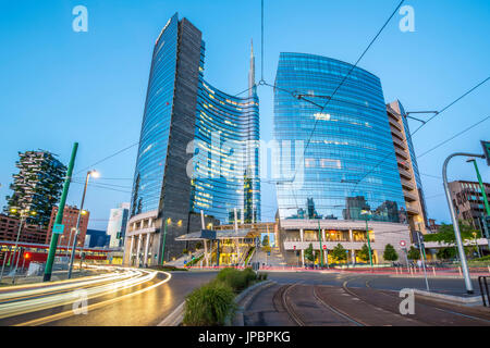 Milan, Lombardy, Italy. Skyscrapers of Porta Nuova business district at dusk with passing cars lights. Stock Photo