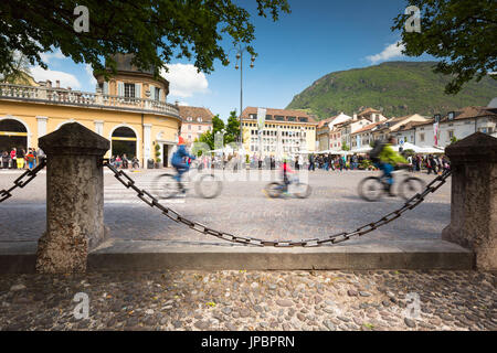 a particolar view of the Walther Square full of people and with three bikers in fore ground, Bolzano province, South Tyrol, Trentino Alto Adige, Italy, Europe, Stock Photo