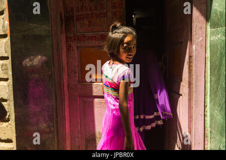 Varanasi, Uttar Pradesh, India, Asia. Girl entering house. Stock Photo