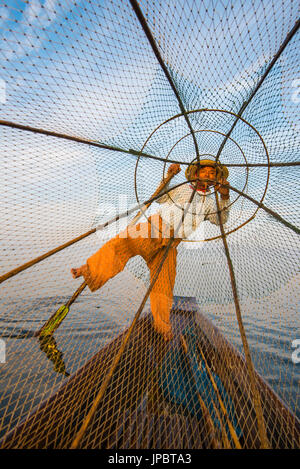 Inle lake,  Nyaungshwe, Shan state, Myanmar. Fisherman looking through the fishing net. Stock Photo