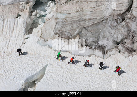 Mountaineers walk on Lys glacier near the Gnifetti refuge in Monte Rosa Massif (Gressoney, Lys Valley; Aosta province, Aosta Valley, Italy, Europe) Stock Photo