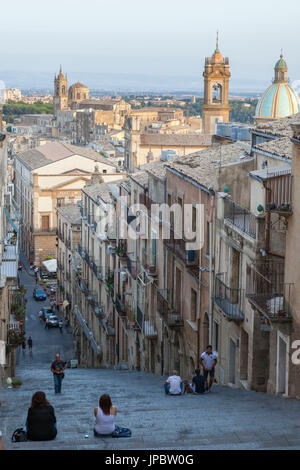 Tourists on flight of steps admire the old town and dome of cathedral of Caltagirone province of Catania Sicily Italy Europe Stock Photo