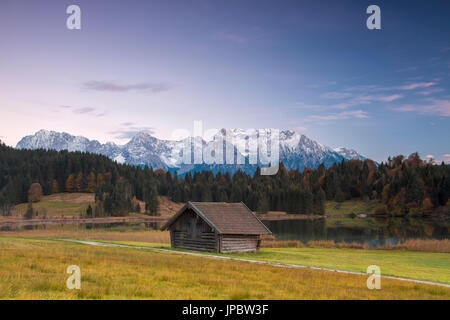 Wooden hut frames the alpine lake surrounded by the Alps Geroldsee Krün Garmisch Partenkirchen Upper Bavaria Germany Europe Stock Photo