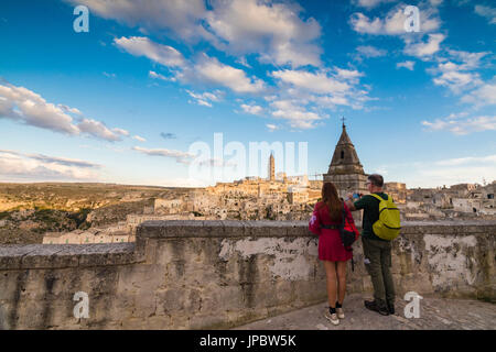 Tourists admire the ancient town and historical center called Sassi perched on rocks Matera Basilicata Italy Europe Stock Photo