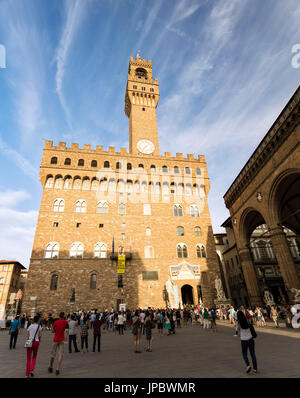 Tourists admire the facade of Palazzo Vecchio from Piazza Della Signoria Florence Tuscany Italy Europe Stock Photo