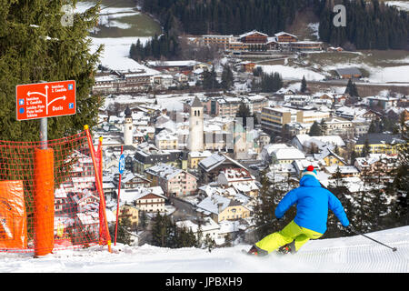 Skier on ski slopes with the alpine village of San Candido in the background Val Pusteria Dolomites Bolzano South Tyrol Italy Europe Stock Photo