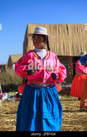 Child leaving on the Uros floating islands on Lake Titicaca, Puno, Peru Stock Photo