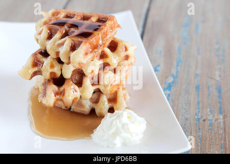 Maple syrup waffle with whipped vanilla ice cream Stock Photo - Alamy
