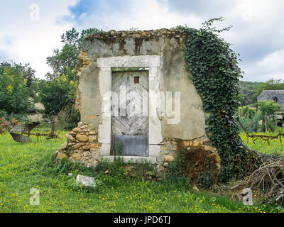 1736 doorway... only remains of house, Lacommande, France. Stock Photo