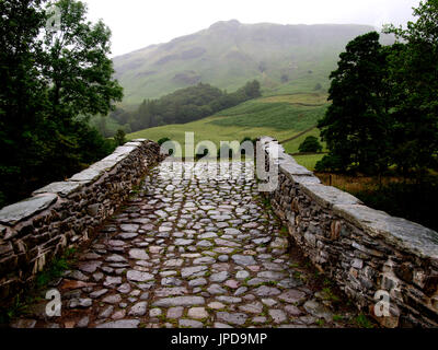 Old cobbled bridge over the River Derwent,  near Rosthwaite, The Lake District, Cumbria, UK Stock Photo