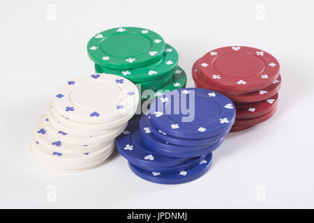 Four stacks of different colored casino chips for placing a bet while gambling at the tables or wheel on a white background Stock Photo