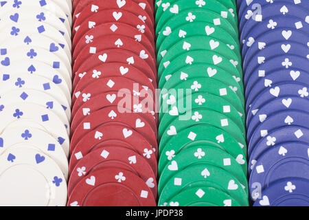 Colorful background of rows of casino chips in red, green, white and blue in a full frame view for a gambling concept Stock Photo