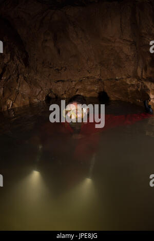Diving on a cave, Liguria, Italy, Europe. A woman speleologist filming the cave scuba diver. Stock Photo