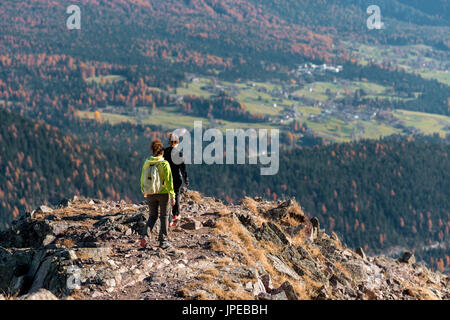 Italy, Trentino Alto Adige, Non valley, two women hikers descend from the top of Luco Mount. Stock Photo