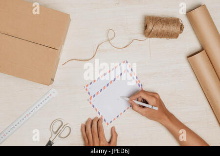 Sending a letter. Air mail envelope on the wood table Stock Photo