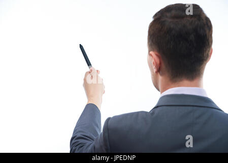 Man teacher pointing with pen on white desk view from back isolated Stock Photo