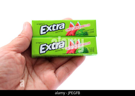 Hand holding Wrigley's Chewing Gum isolated against white background Stock Photo