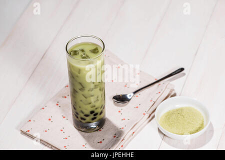 Boba / Bubble tea. Homemade Matcha Milk Tea with Pearls on wooden table. Stock Photo