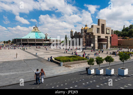 Mexico City, Mexico - June 1, 2014: People at the Basilica of Our Lady of Guadalupe, with the old and the new basilica on the background, in Mexico Ci Stock Photo