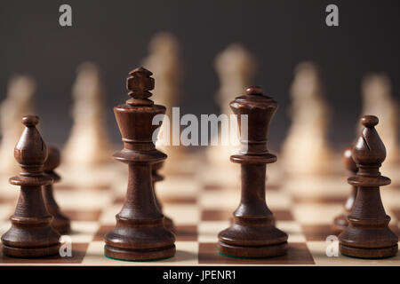 Wooden chess pieces arranged on the chess board before the game. Stock Photo