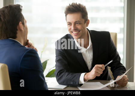 Two smiling positive businessmen laughing, having fun during bus Stock Photo