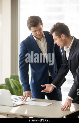 Two appraisers working on architectural project with laptop, bui Stock Photo
