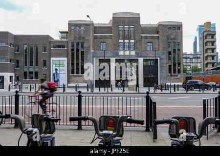 Poplar, London, UK - July 16, 2017:  Poplar Baths, regenerated looking from Chrisp Street with Boris bikes in the foreground. Stock Photo
