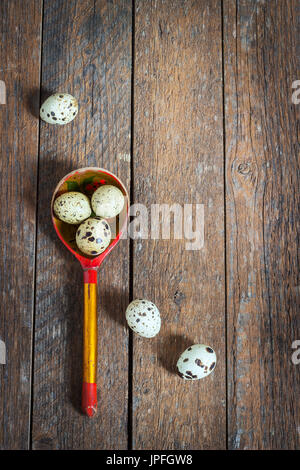 quail eggs in a wooden spoon on old wooden background Stock Photo