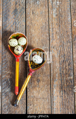 quail eggs in a wooden spoon on old wooden background Stock Photo