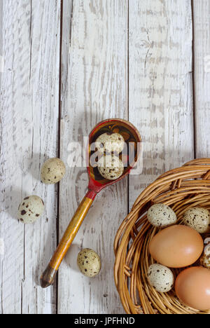 quail eggs in a wooden spoon on old wooden background Stock Photo