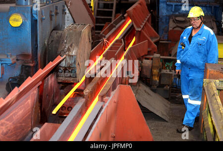 A rolling mill in a metallurgical plant of the ArcelorMittal Ostrava is seen during an extremely hot day in Ostrava, Czech Republic, on August 1, 2017. At the time of heat, workers working in ArcelorMittal Ostrava's hot factories are exposed to excessive working temperatures. In the rolling mill operation its hot stamped plates with a temperature of up to 1200 degrees of Celsius. Employees therefore have a more frequent break mode that they can spend in air-conditioned areas. The company also provides them with more beverages. (CTK Photo/Petr Sznapka) Stock Photo