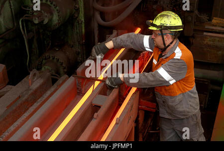 A rolling mill in a metallurgical plant of the ArcelorMittal Ostrava is seen during an extremely hot day in Ostrava, Czech Republic, on August 1, 2017. At the time of heat, workers working in ArcelorMittal Ostrava's hot factories are exposed to excessive working temperatures. In the rolling mill operation its hot stamped plates with a temperature of up to 1200 degrees of Celsius. Employees therefore have a more frequent break mode that they can spend in air-conditioned areas. The company also provides them with more beverages. (CTK Photo/Petr Sznapka) Stock Photo