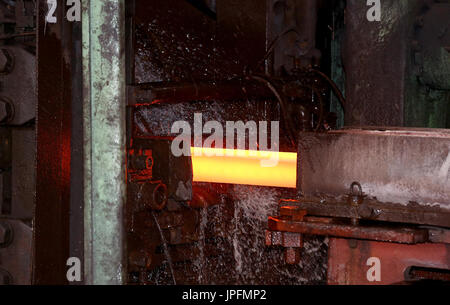 A rolling mill in a metallurgical plant of the ArcelorMittal Ostrava is seen during an extremely hot day in Ostrava, Czech Republic, on August 1, 2017. At the time of heat, workers working in ArcelorMittal Ostrava's hot factories are exposed to excessive working temperatures. In the rolling mill operation its hot stamped plates with a temperature of up to 1200 degrees of Celsius. Employees therefore have a more frequent break mode that they can spend in air-conditioned areas. The company also provides them with more beverages. (CTK Photo/Petr Sznapka) Stock Photo