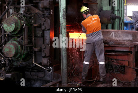 A rolling mill in a metallurgical plant of the ArcelorMittal Ostrava is seen during an extremely hot day in Ostrava, Czech Republic, on August 1, 2017. At the time of heat, workers working in ArcelorMittal Ostrava's hot factories are exposed to excessive working temperatures. In the rolling mill operation its hot stamped plates with a temperature of up to 1200 degrees of Celsius. Employees therefore have a more frequent break mode that they can spend in air-conditioned areas. The company also provides them with more beverages. (CTK Photo/Petr Sznapka) Stock Photo