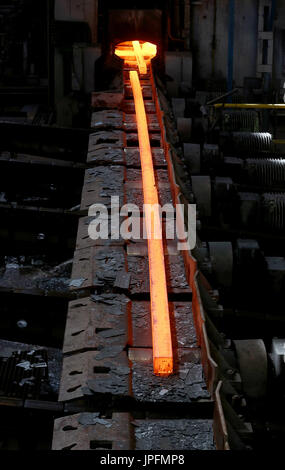 A rolling mill in a metallurgical plant of the ArcelorMittal Ostrava is seen during an extremely hot day in Ostrava, Czech Republic, on August 1, 2017. At the time of heat, workers working in ArcelorMittal Ostrava's hot factories are exposed to excessive working temperatures. In the rolling mill operation its hot stamped plates with a temperature of up to 1200 degrees of Celsius. Employees therefore have a more frequent break mode that they can spend in air-conditioned areas. The company also provides them with more beverages. (CTK Photo/Petr Sznapka) Stock Photo